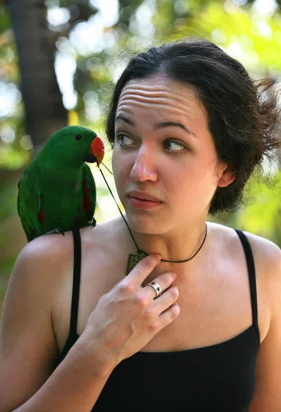 Girl with a green parrot — Stock Photo, Image