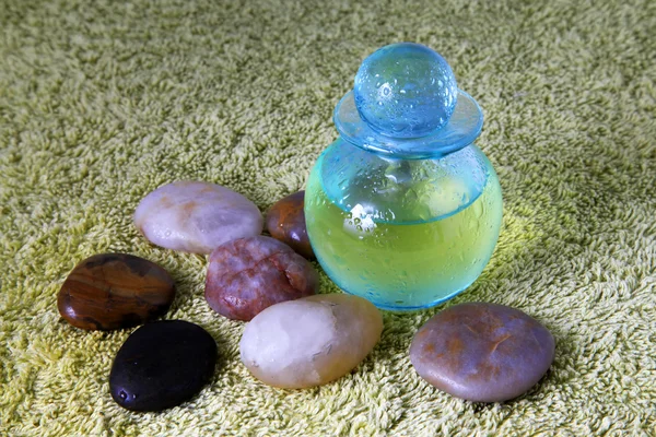 Blue bottle with massage oil — Stock Photo, Image
