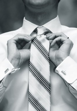 Man tying necktie clipart