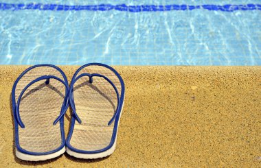 Women's sandals on the feet of the pool clipart