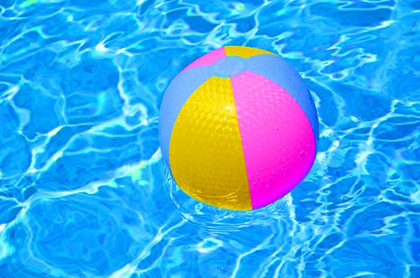 Multicolored Beach ball in swimming pool — Stock Photo, Image