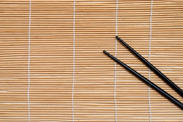 Japanese chopsticks on bamboo placemat background — Stock Photo, Image