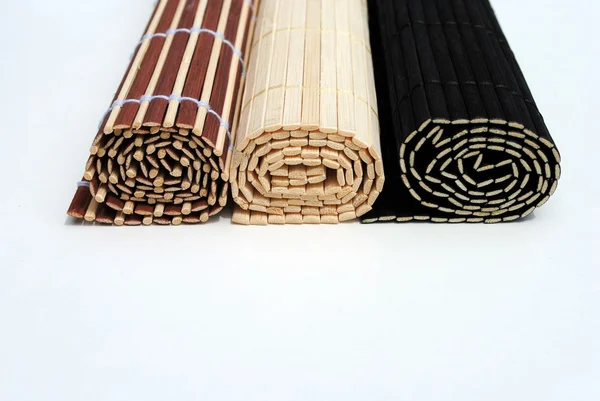 Set of three rolled bamboo placemat on white background — Stock Photo, Image
