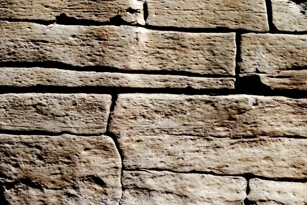 Ruw en onregelmatige stenen achtergrond — Stockfoto