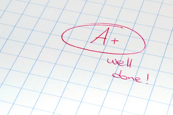 A+ mark on a squared paper — Stock Photo, Image
