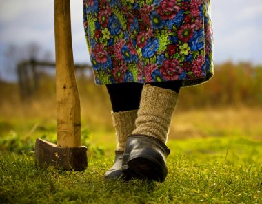 An old lady with an ax clipart