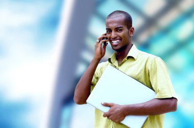 küçük mutlu bir adam ya da öğrenci dizüstü bilgisayar ve telefon iş