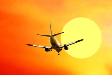 Airplane on sunset sky clipart