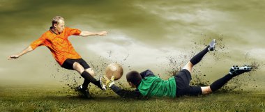 Shoot of football player and goalkeeper on the outdoors field clipart