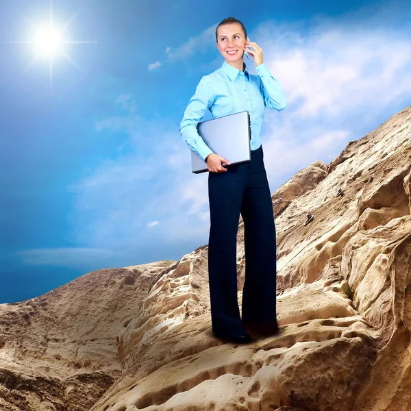 Happy Businesswoman standing with laptop on the mountain under b — Stock Photo, Image