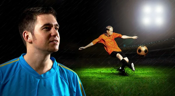 Retrato del jugador de fútbol en el campo bajo la lluvia nocturna — Foto de Stock