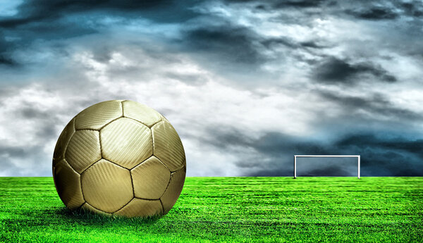 Soccer ball on green grass and sky background