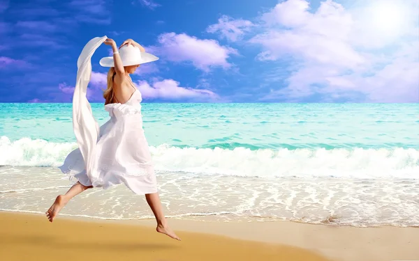 Young beautiful women in the white on the sunny tropical beach — Stock Photo, Image