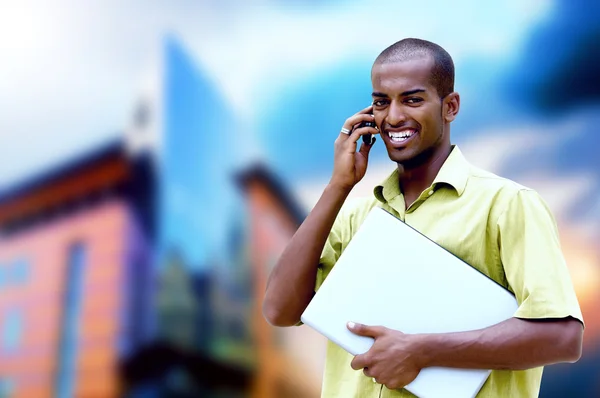 Young happy man or student with laptop and phone on the business — Stock Photo, Image