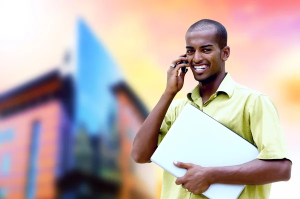 Young happy man or student with laptop and phone on the business — Stock Photo, Image