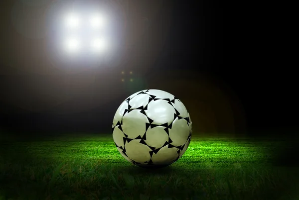 Balón de fútbol en el campo de estadio con luz — Foto de Stock
