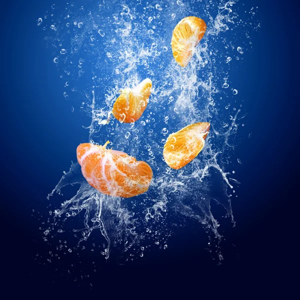 stock image Water drops around mandarin on blue background