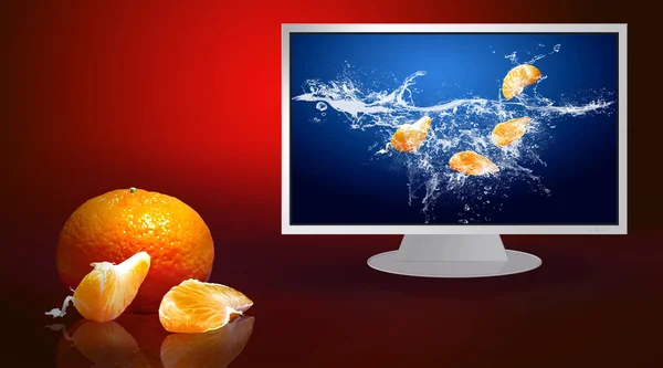 Fresh fruits in water on monitor — Stock Photo, Image