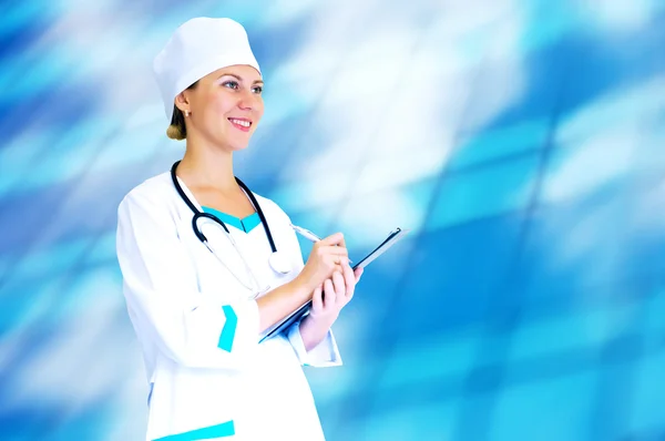 Smiling medical doctor with stethoscope on the hospitals backgro — Stock Photo, Image