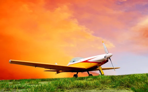 Airplane on sunset sky — Stock Photo, Image