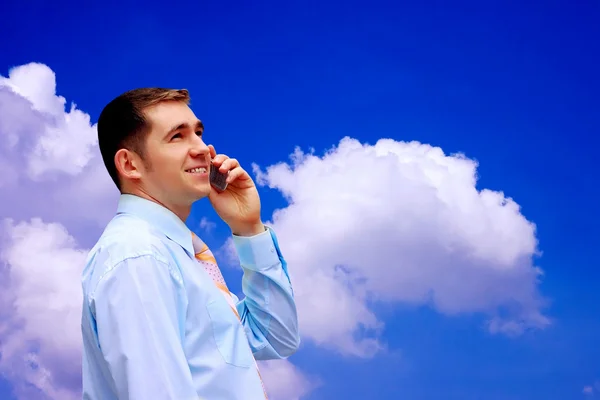 Businessman on sky background — Stock Photo, Image