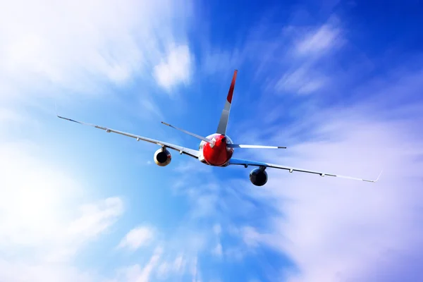 Airplane at fly on the sky with clouds — Stock Photo, Image