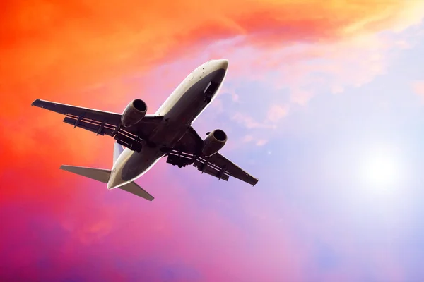 Airplane on sunset sky — Stock Photo, Image