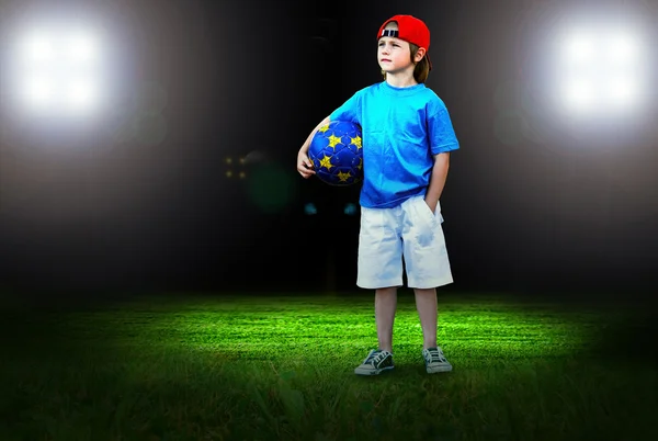Happiness young boy on the field of stadium with light — Stock Photo, Image