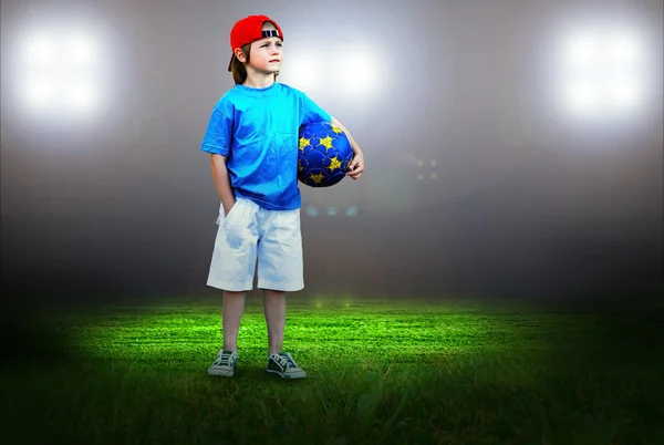 Happiness young boy on the field of stadium with light — Stock Photo, Image