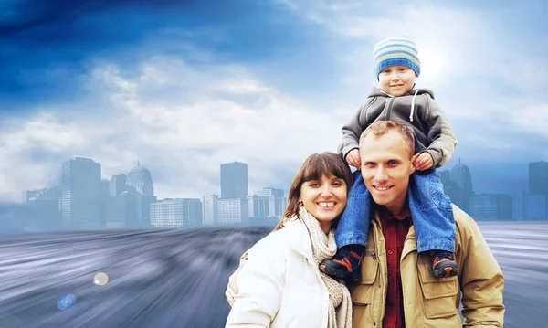 Happy family portrait outdoors smiling on the road in city — Stock Photo, Image