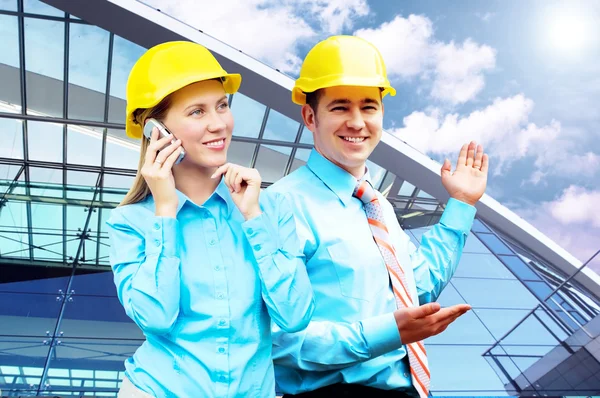 Young architects wearing a protective helmet standing on the bui — Stock Photo, Image
