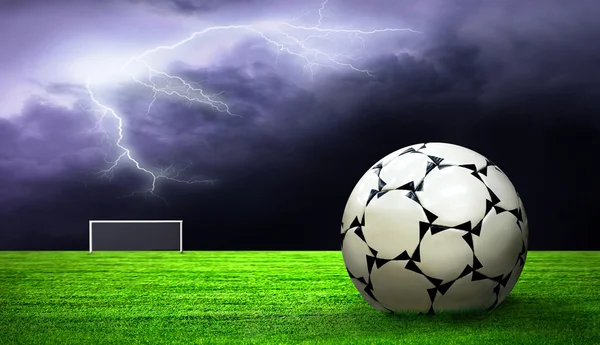 Soccer ball on green grass and sky background — Stock Photo, Image