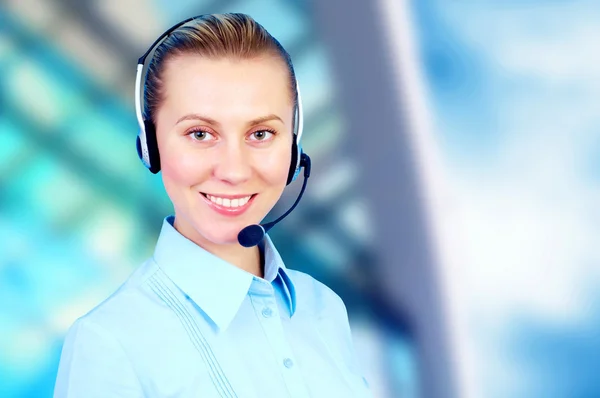 Happiness businesswoman speak in headphones on blur business arc — Stock Photo, Image