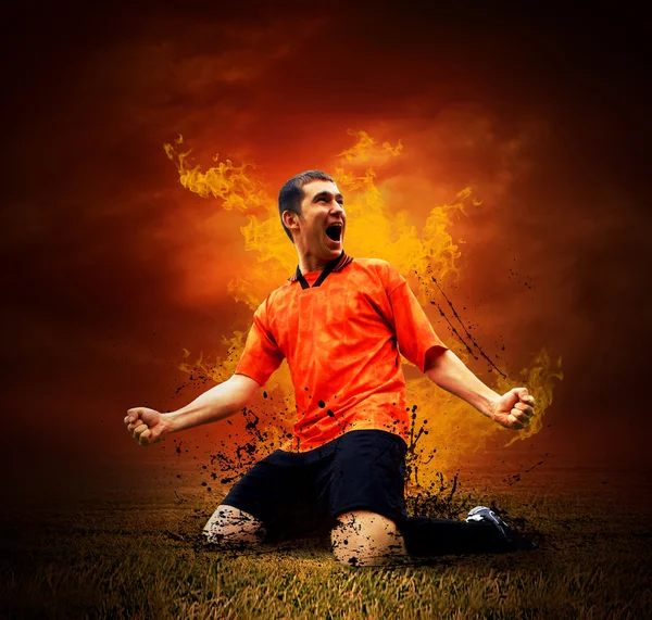 Piłkarz w pożary płomień na polu na zewnątrz — Zdjęcie stockowe