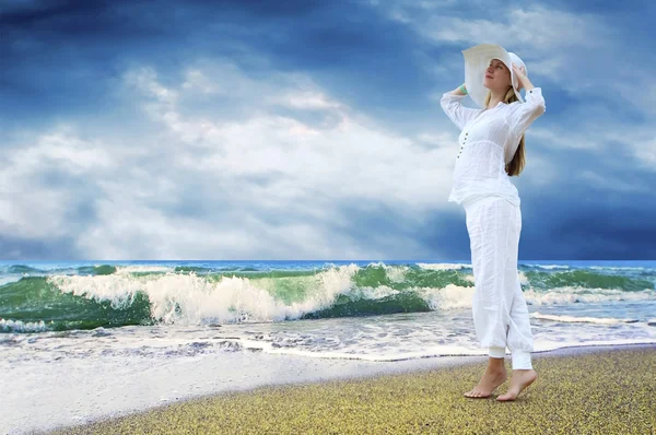 Young beautiful women in the white on the beach — Stock Photo, Image