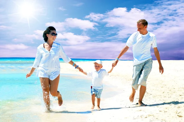 Vista della giovane famiglia felice che si diverte sulla spiaggia — Foto Stock