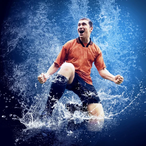 Water drops around football player under water on blue background — Stock Photo, Image