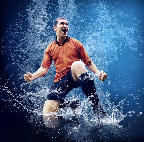 Water drops around football player under water on blue background — Stock Photo, Image