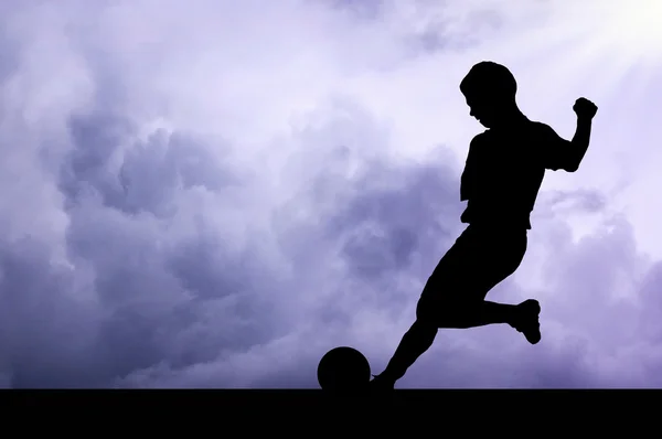 Silhouettes of footballers on the sunset sky — Stock Photo, Image