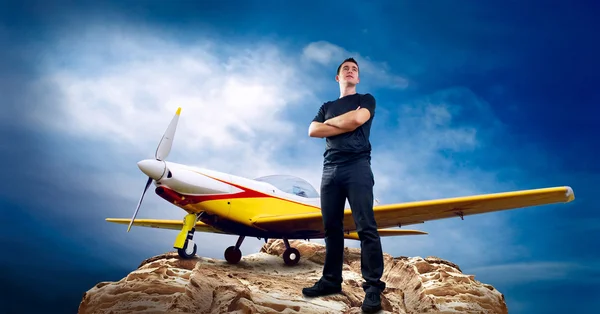 Man on the top of mountain and airplane — Stock Photo, Image