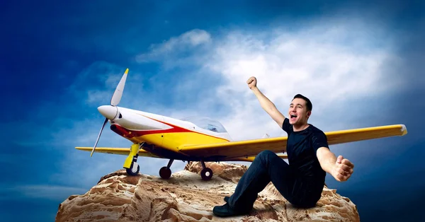 Man on the top of mountain and airplane — Stock Photo, Image