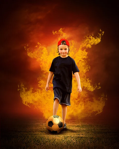 Child with ball in fires flame on the outdoors field — Stock Photo, Image