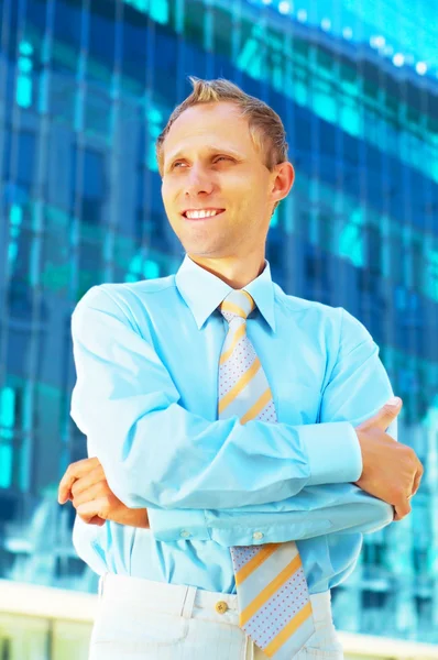 Happiness businessman on blur business architecture background — Stock Photo, Image