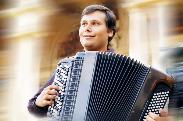 stock image Male playing on the accordion against a grunge background