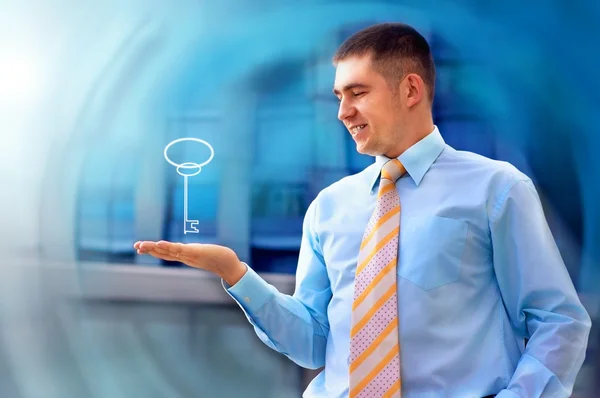 Happy businessman with key in his hand — Stock Photo, Image