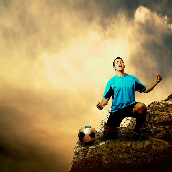 Footballer on the top of mountain — Stock Photo, Image
