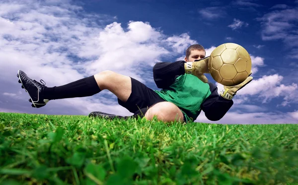 Jump of football goalman on the outdoor field — Zdjęcie stockowe