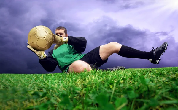 Jump of football goalman on the outdoor field — Zdjęcie stockowe