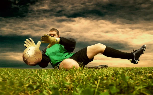 Jump of football goalman on the outdoor field — Stock Photo, Image
