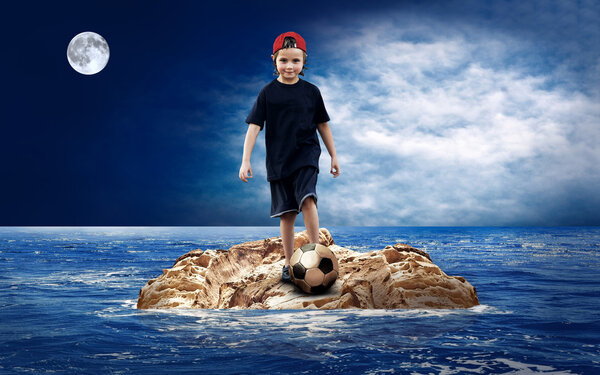 Child with soccerball on the island in sea.